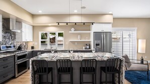 A modern kitchen with a large island, built-in oven, and stainless steel appliances. - Pet-friendly! Near downtown Oceanside - Sea Spray (Oceanside)
