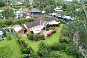A residential property with a large house, a covered patio, and a well-maintained garden. - *Direct Access to Orion Beach* Jervis Bay Beachfront (Vincentia)