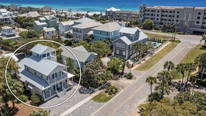 A coastal residential area with a large hotel, multiple-story buildings, and a clear view of the ocean. - Flirty Flamingo- Pet-Friendly Vacation Home Near Beach with Private Pool Area (Destin)