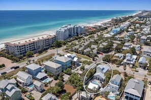 A coastal residential area with a large hotel, multiple houses, and a beach. - Flirty Flamingo- Pet-Friendly Vacation Home Near Beach with Private Pool Area (Destin)