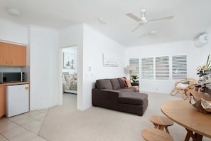 Enjoy a comfortable stay in this well-appointed living space with a kitchen, seating area, and dining table.