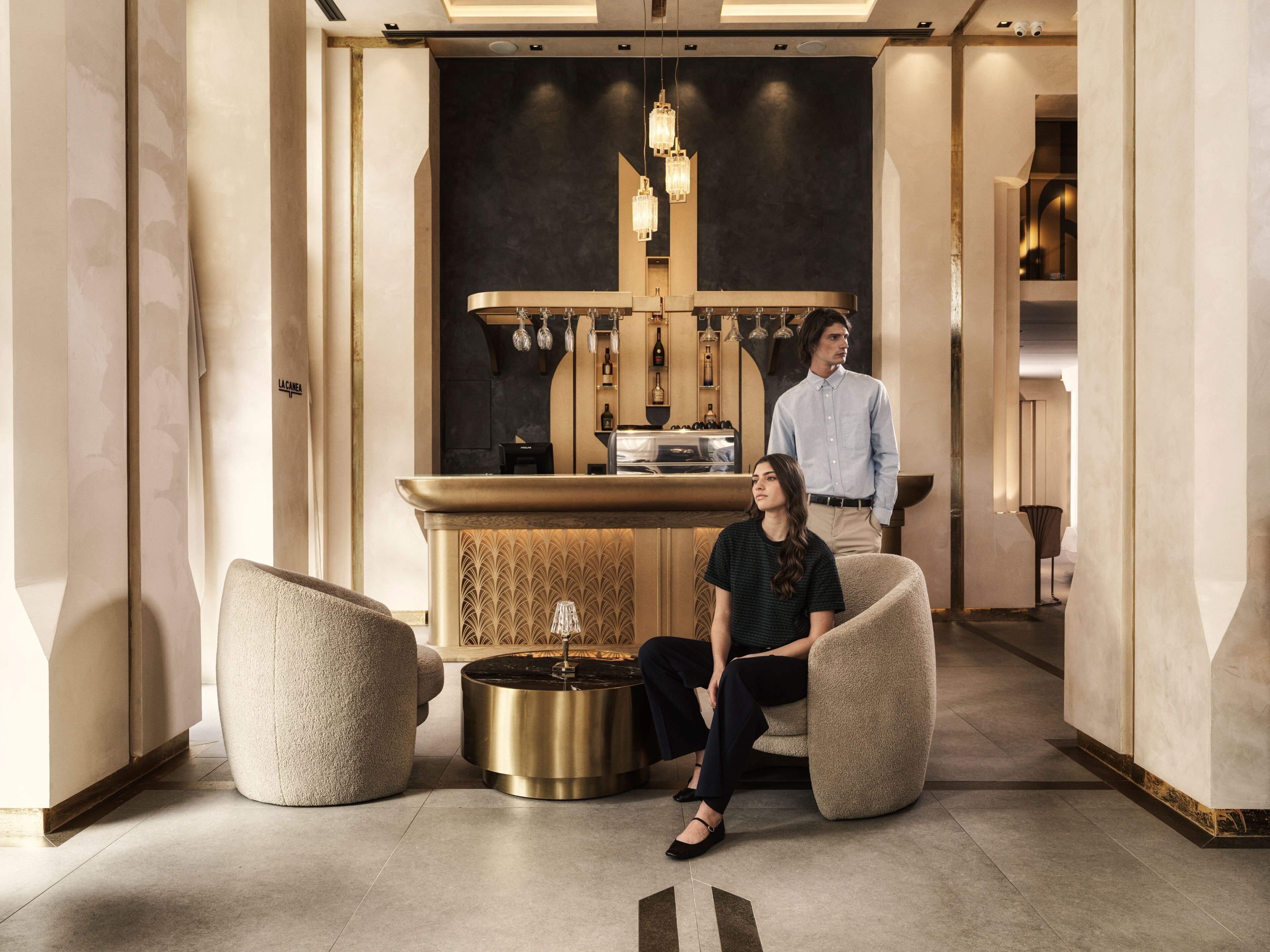 A modern interior with a bar area, seating, and a decorative lamp.