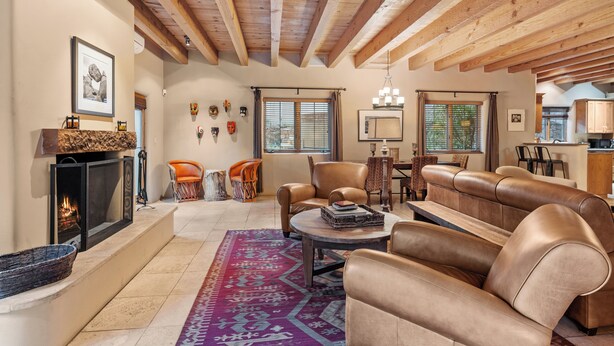 A spacious living room with a fireplace, leather sofas, and a patterned rug. - Casa La Vereda | Luxury Retreat Near Plaza (Santa Fe)