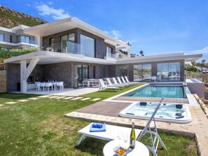 A modern two-story house with a swimming pool, outdoor seating, and a hot tub. - Villa Atina by Interhome (Jávea)