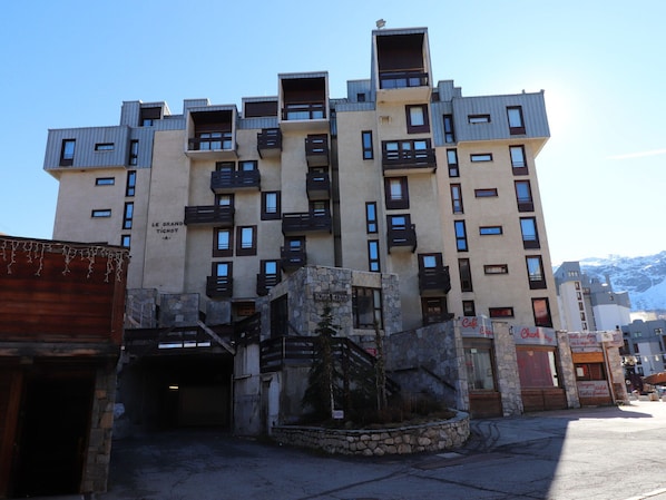 Un edificio de varios pisos con balcones y fachada de piedra.