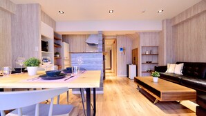 Un espace de vie moderne comprenant un coin repas, une cuisine et un coin salon.