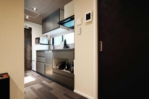 Enjoy cooking in this well-equipped kitchen with appliances and a stainless steel range hood.