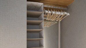 A walk-in closet with built-in shelves and a hanging rod. - Real Life AOYAMA 2BR suite 5pax 3bed 3min metro (Minato)
