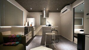 A compact, modern apartment with a kitchenette, a dining area, and a living space. - Real Life AOYAMA 2BR suite 5pax 3bed 3min metro (Minato)