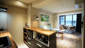A modern kitchen with built-in appliances, a wooden island, and a dining area with a view.