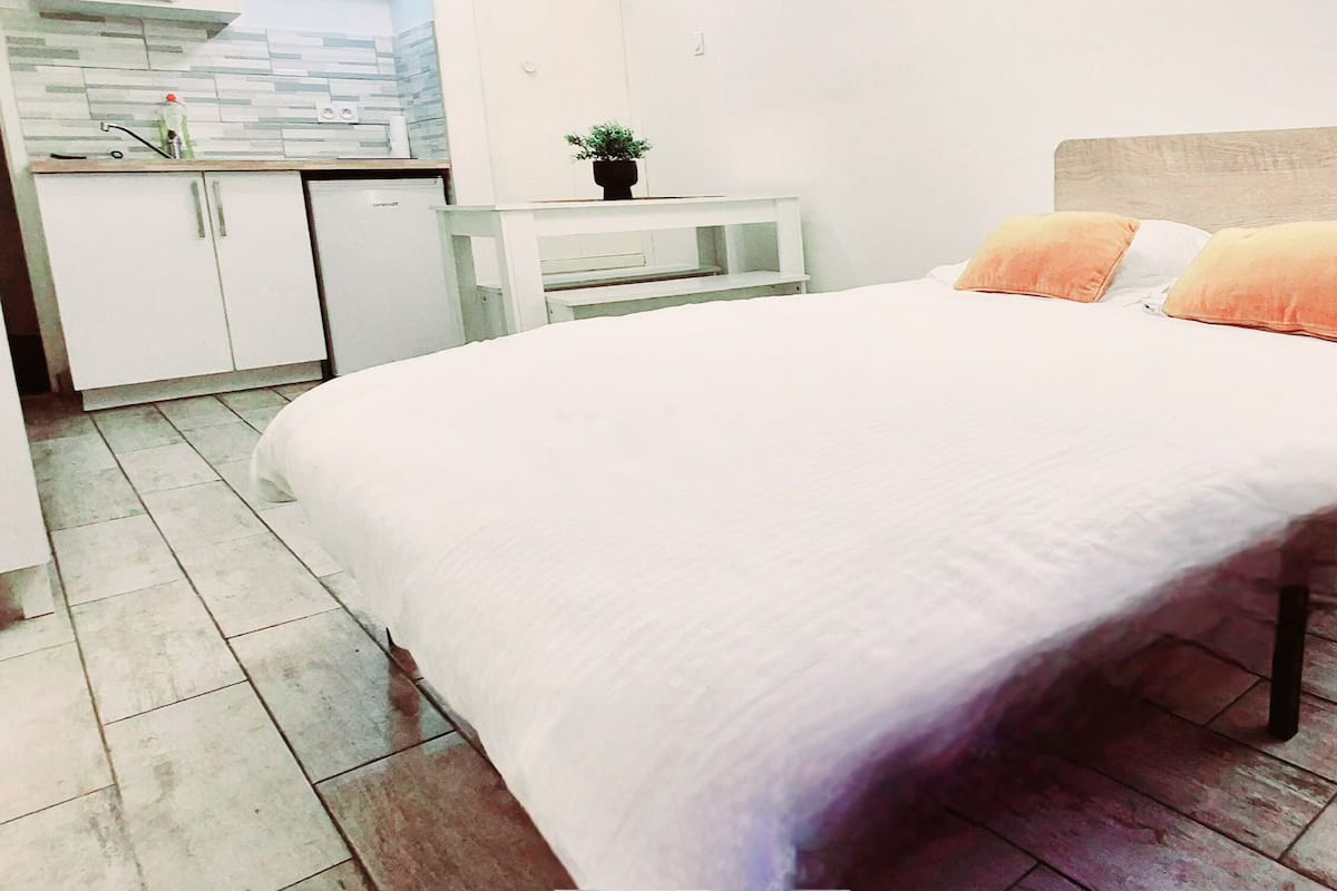 Relax in comfort with a large bed and a convenient nightstand.