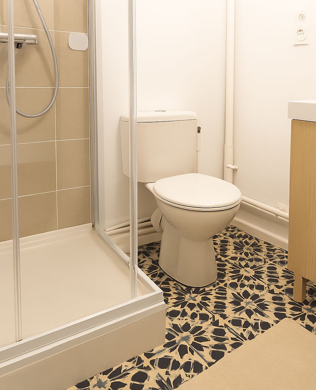 A bathroom with a shower, toilet, and sink.