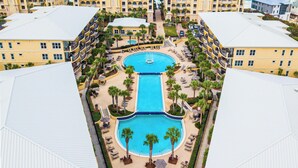 A resort with a central pool, multiple balconies, and a view of the ocean. - Adagio by Southern Vacation Rentals (Santa Rosa Beach)