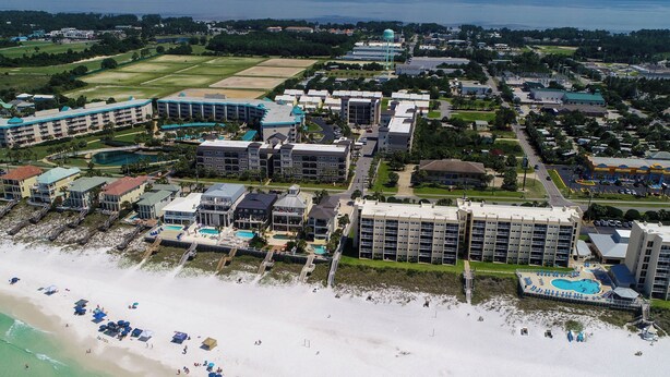 An aerial view of a coastal hotel with multiple buildings, a beach, and a swimming pool. - Alerio by Southern Vacation Rentals (Miramar Beach)