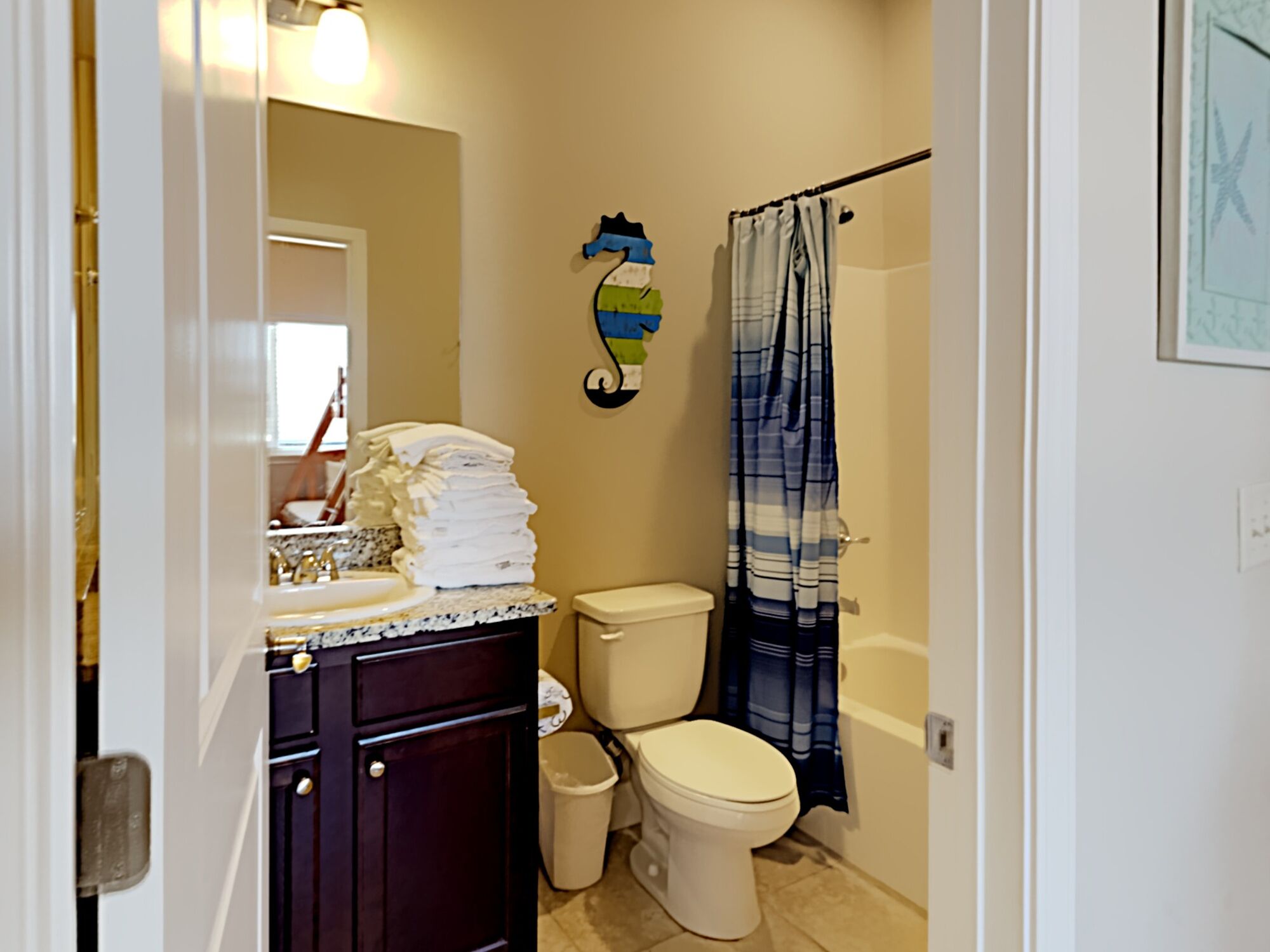 A bathroom with a sink, toilet, and shower curtain.