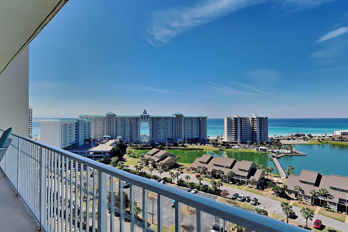 A hotel with multiple high-rise buildings, a marina, and a clear view of the ocean.