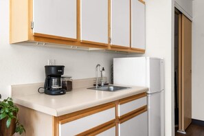 Fridge, microwave, coffee/tea maker, cookware/dishes/utensils