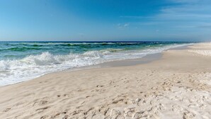 A beach with a clear sky and waves. - Beach Colony East by Southern Vacation Rentals (Pensacola)