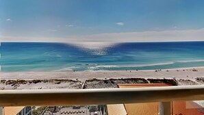 A beach view from a balcony with a clear sky. - Beach Club by Southern Vacation Rentals (Pensacola Beach)
