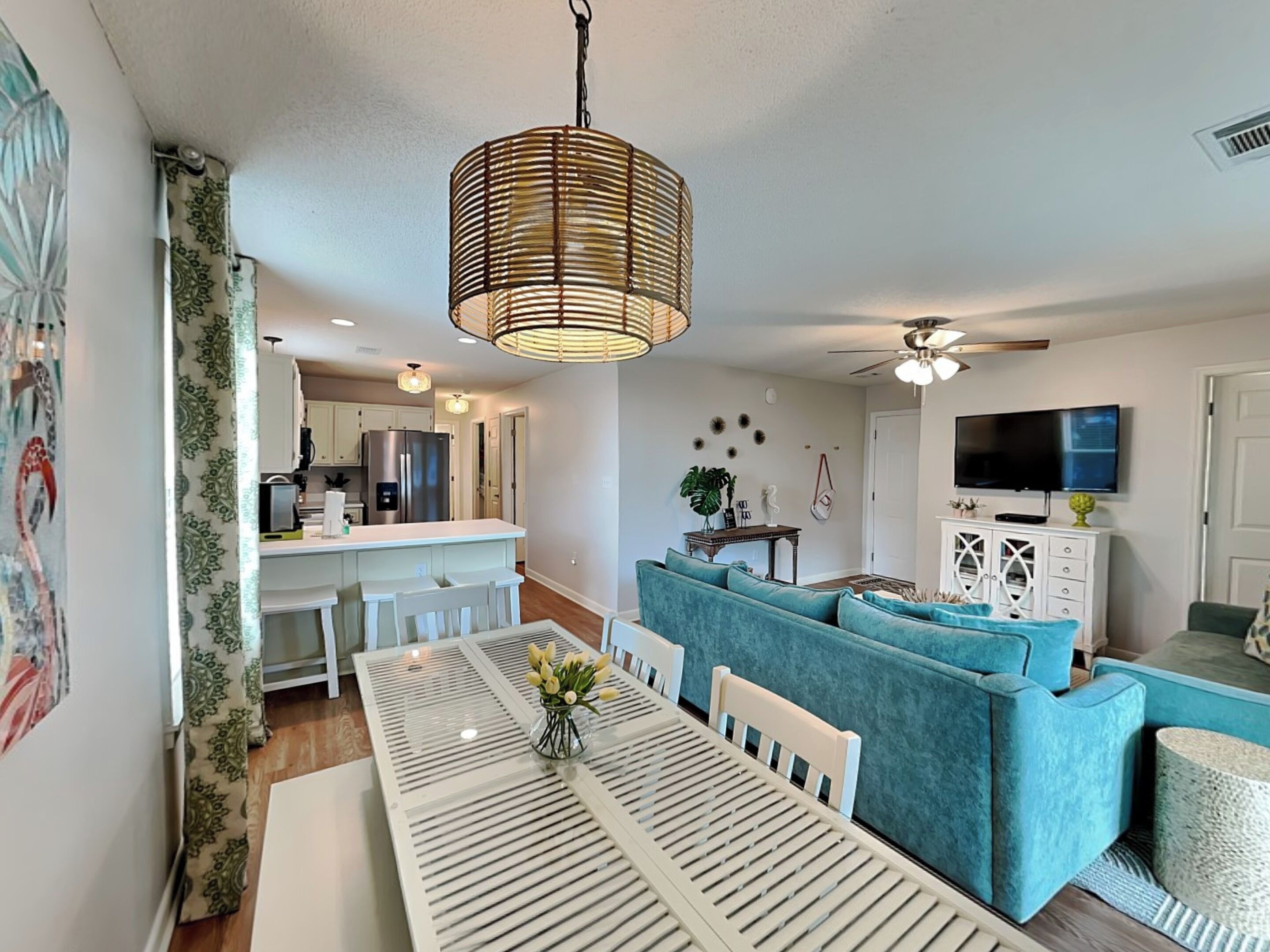 A modern living space with a dining area, kitchen, and seating area.