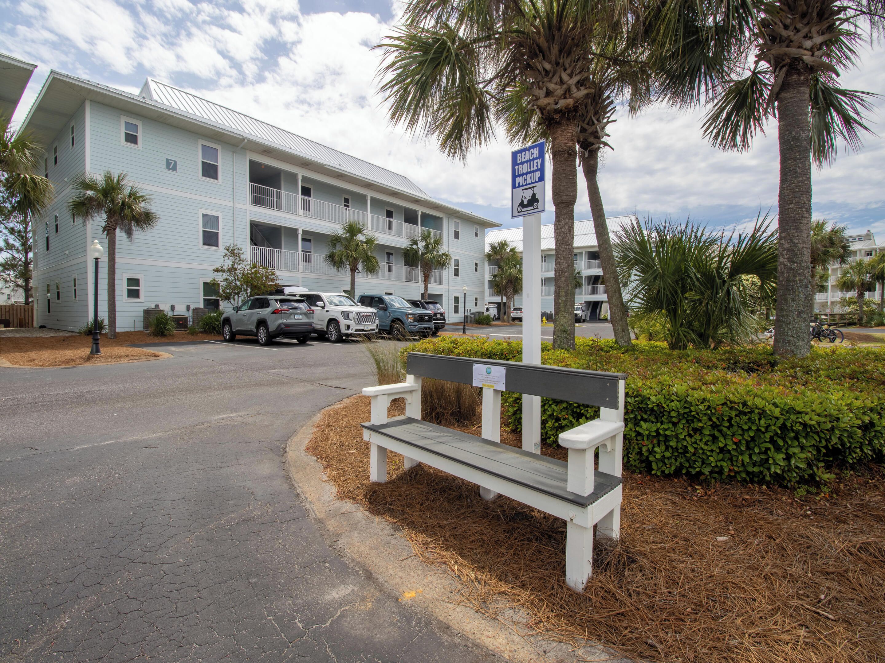 A building with a sign for a beach trolley pickup.