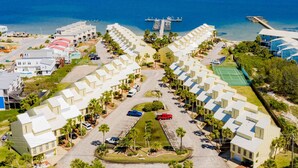 A coastal resort with modern architecture, a marina, and a tennis court. - Buena Vida Townhomes by Southern Vacation Rentals (Navarre)