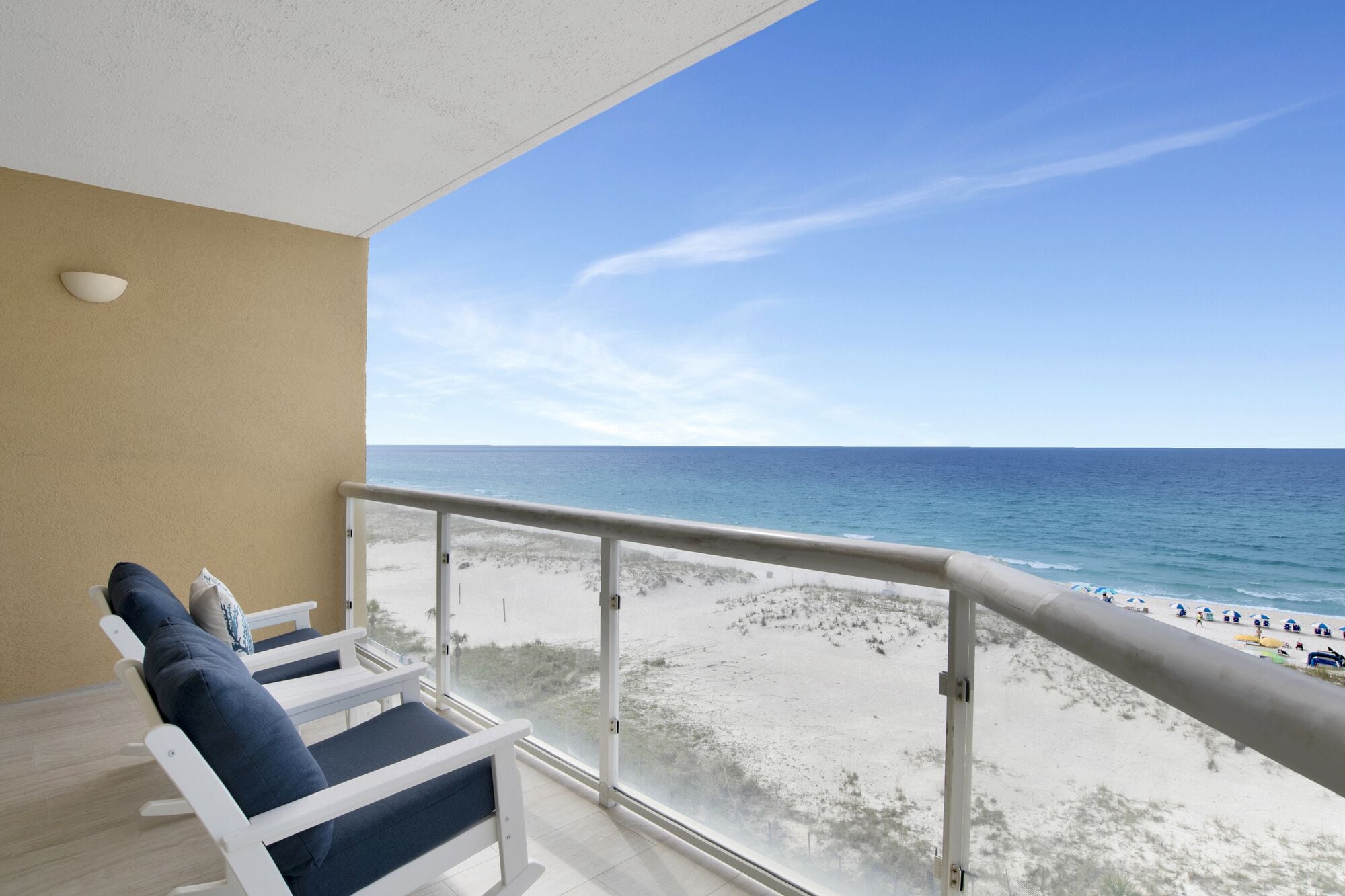 A balcony with a view of a beach and ocean.