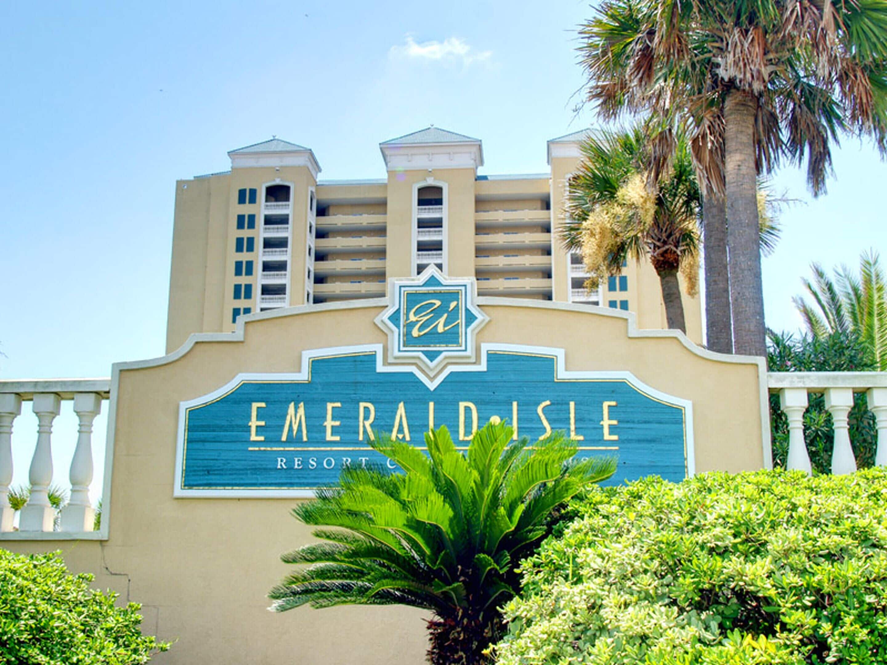 The exterior of the Emerald Isle Resort with a prominent sign featuring the resort's name and logo.