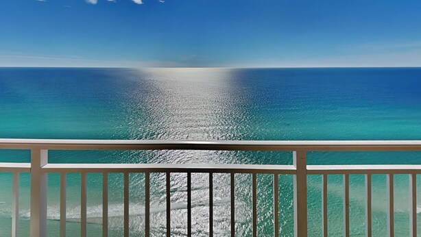 A balcony with a view of the ocean and a clear sky. - Emerald Beach by Southern Vacation Rentals (Panama City Beach)