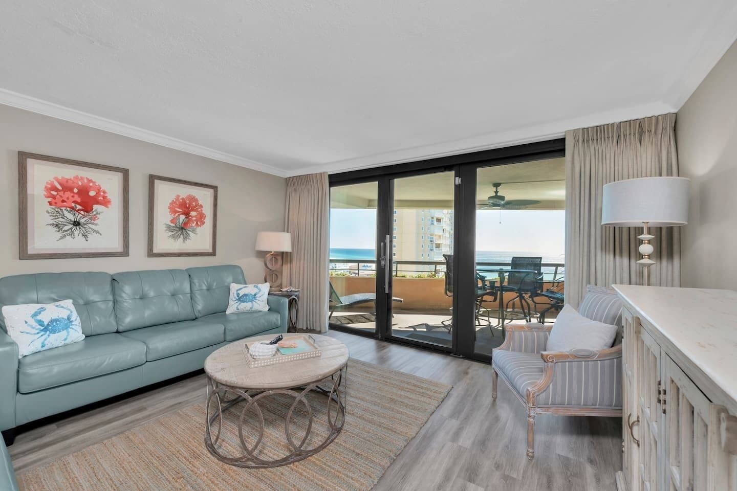 A modern living room with a sofa, a round coffee table, and a dining area with a chair and table.