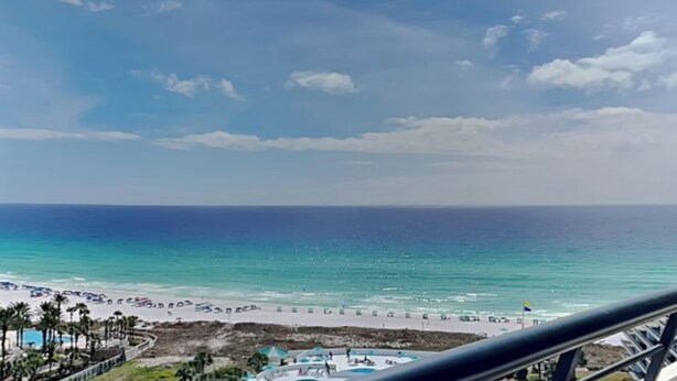 A coastal hotel with a beach view, a pool area, and a clear sky. - Edgewater by Southern Vacation Rentals (Miramar Beach)