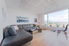 Deluxe Apartment | Living area | 50-inch Smart TV with digital channels, TV, heated floors - Sea & City View - Luxurious - Hiking (Argir)