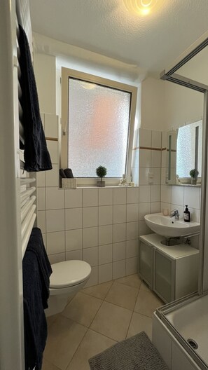Shower, hair dryer, towels, toilet paper