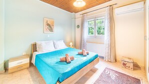 Une chambre à coucher avec un lit, un plafond en bois, une fenêtre et une table de chevet.