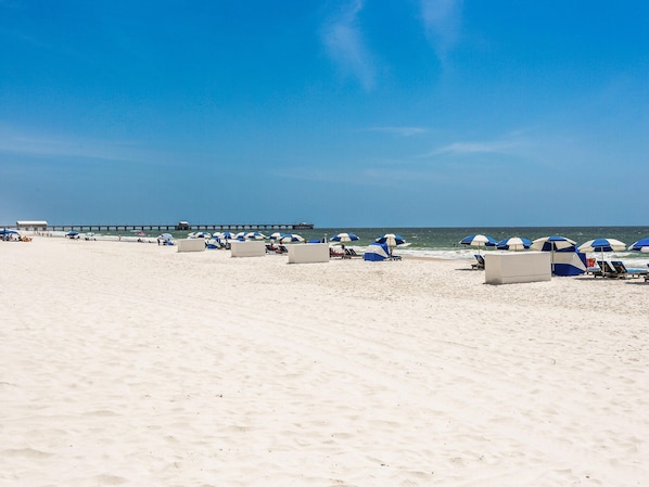 Relax on the beach with comfortable lounge chairs and umbrellas.