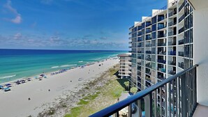 A beachfront hotel with multiple balconies overlooking the ocean and beach. - Majestic Beach Towers II by Resort Collection (Panama City Beach)