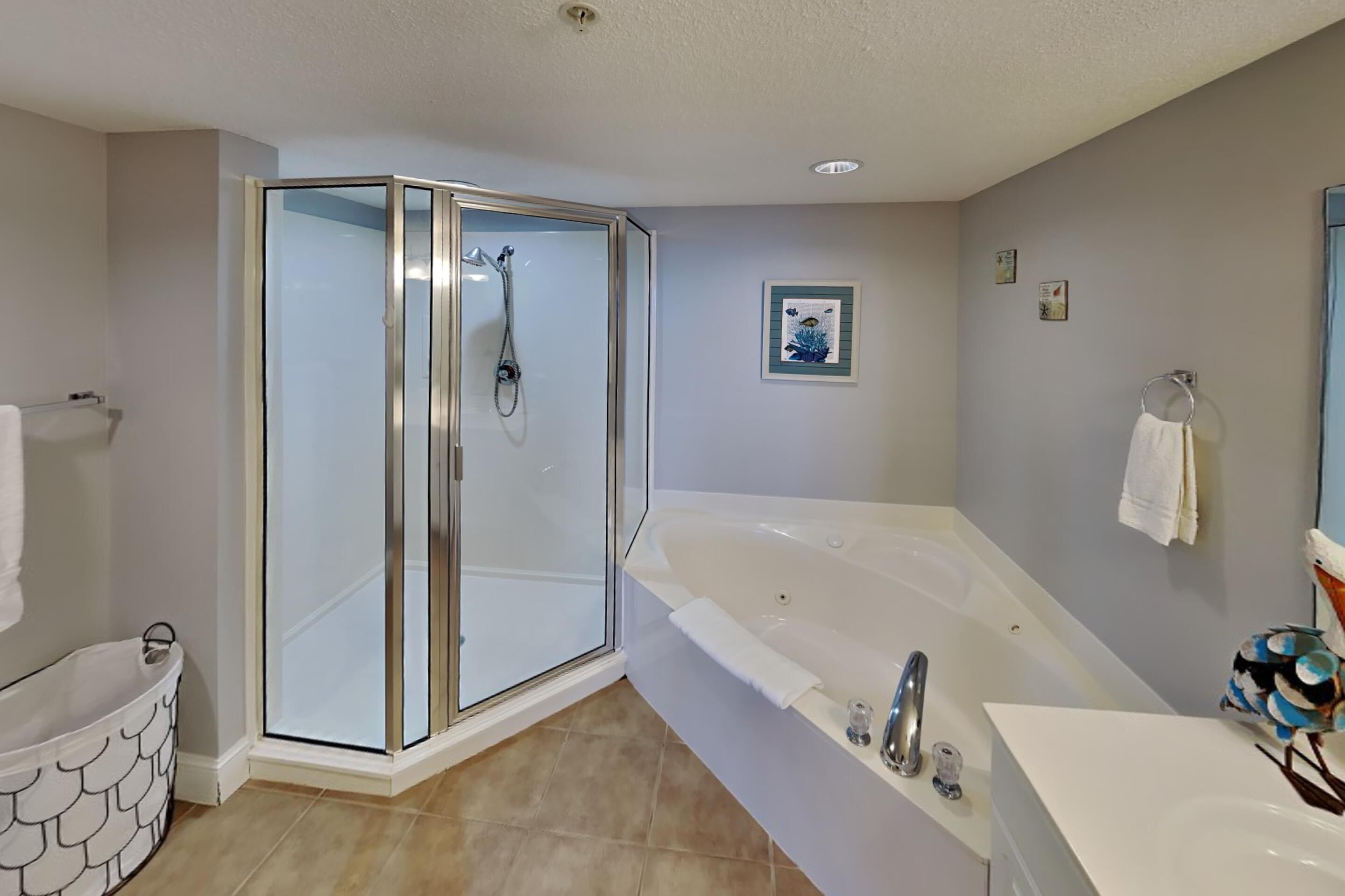 A modern bathroom with a glass-enclosed shower, a freestanding bathtub, and a vanity with a sink.