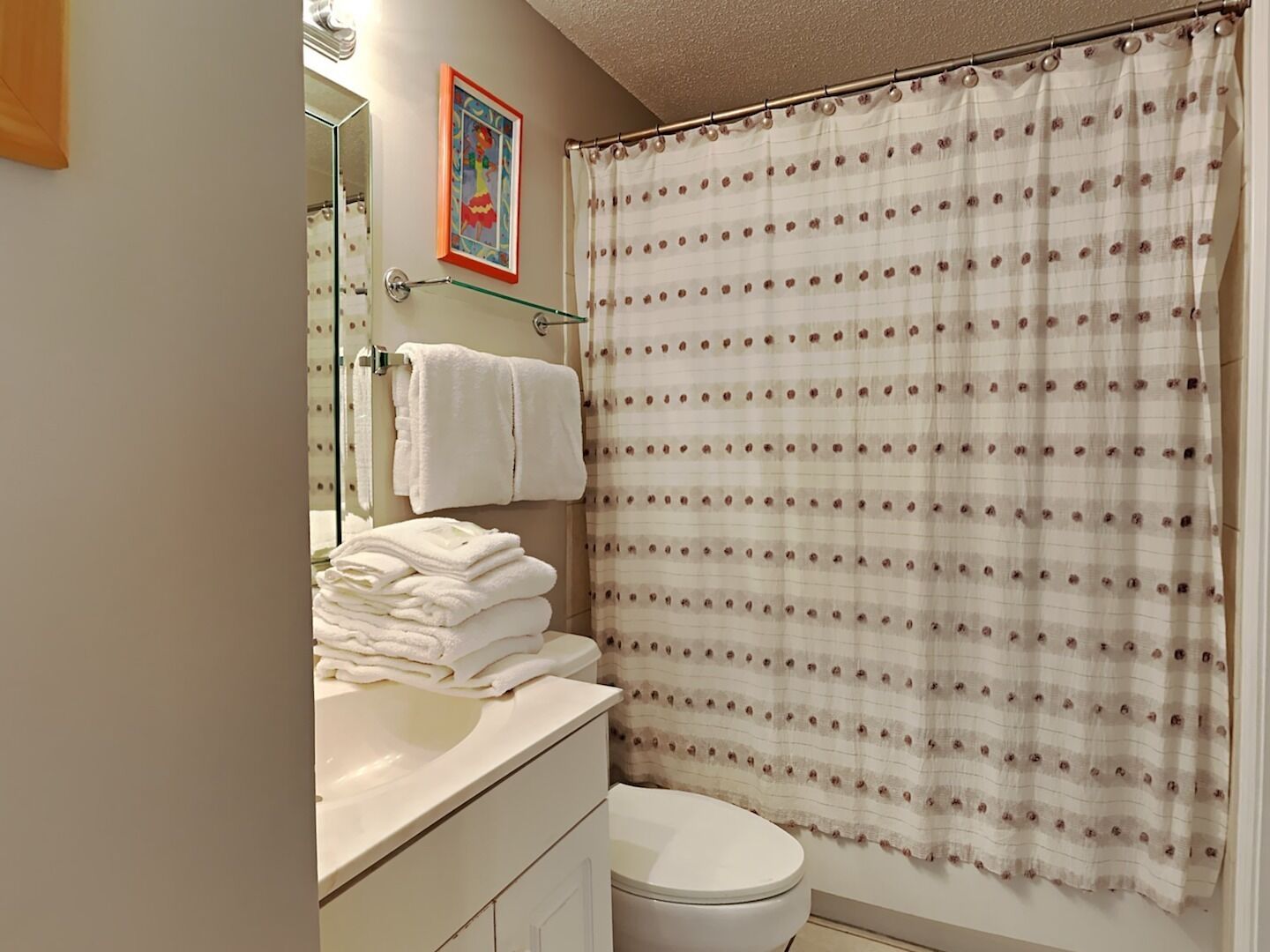 Un baño con un lavabo blanco, un inodoro y una cortina de ducha.