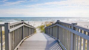 A wooden boardwalk leading to a beach with a clear sky. - Perdido Towers by Southern Vacation Rentals (Pensacola)