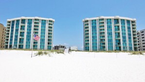 A beachfront hotel with a modern design, featuring multiple floors and balconies. - Perdido Towers by Southern Vacation Rentals (Pensacola)