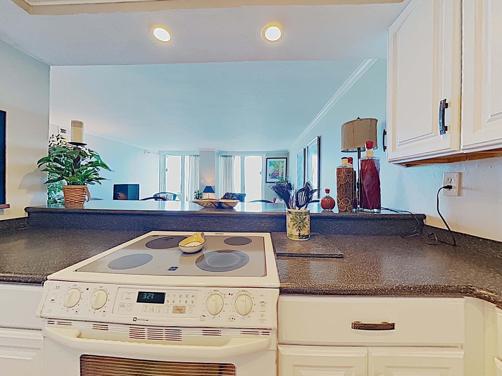 A kitchen with a stove, cabinets, and a countertop.