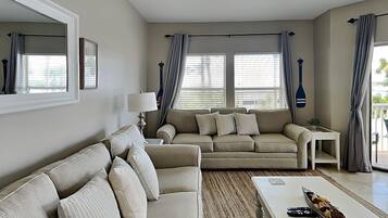 A living room with two sofas, a coffee table, and a lamp.