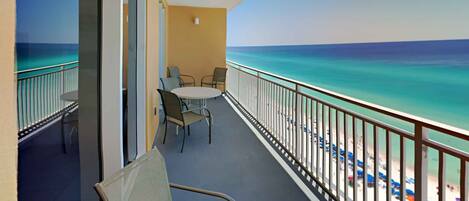 A balcony with a view of the ocean and beach.