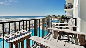 A balcony with a view of the beach and a pool. - Sea Oats by Southern Vacation Rentals (Fort Walton Beach)