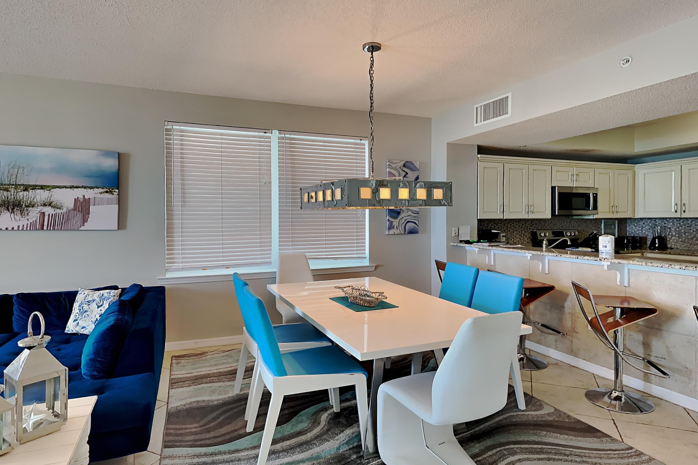 A modern kitchen with white cabinets, a microwave, and a coffee maker.