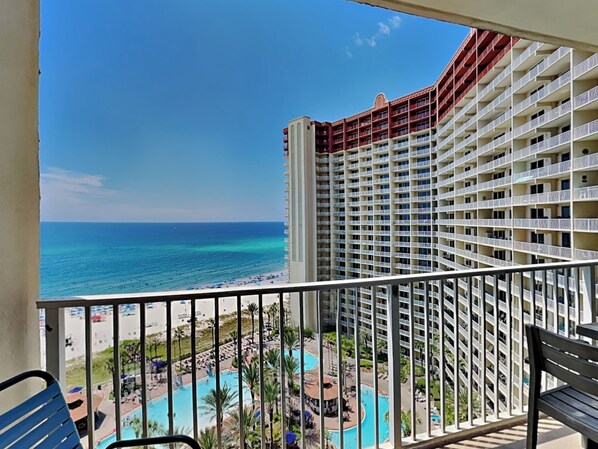 A high-rise hotel with a view of the ocean and a pool area. - Shores of Panama by Resort Collection (Panama City Beach)