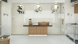 A modern reception area with a wooden reception desk, framed animal artwork on the wall, and a glass partition. - 1 Bed Flat - Sleeps 2 - Parking - Wifi (Tunis)