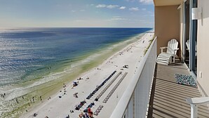 A balcony with a view of a beach and ocean. - Tidewater Beach Resort by Resort Collection (Panama City Beach)