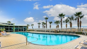 A pool area with lounge chairs and palm trees. - Tidewater Orange Beach by Southern Vacation Rentals (Orange Beach)