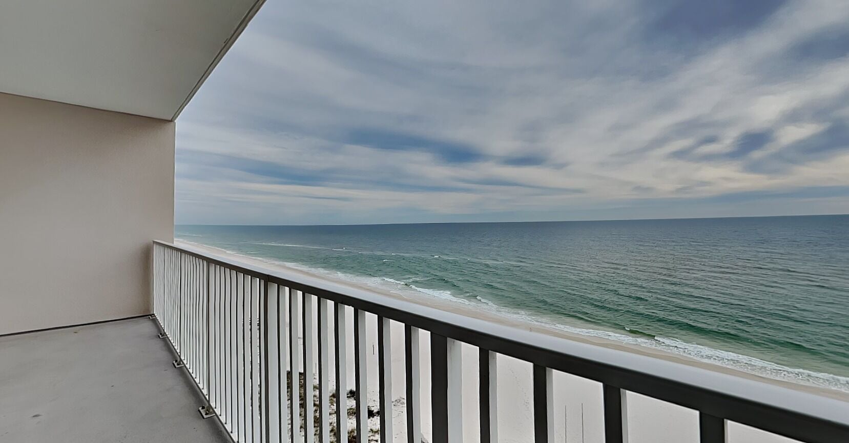 A balcony with a view of the ocean.